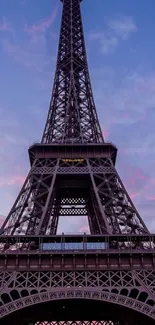 Eiffel Tower at dusk with purple and blue sky.