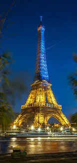 Eiffel Tower glowing against a dark blue night sky.