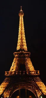 Eiffel Tower lit up against a dark night sky.