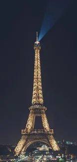 Eiffel Tower glowing at night in Paris.