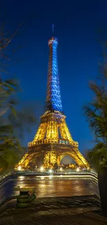 Eiffel Tower beautifully lit against a dark blue night sky in Paris.