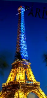 Eiffel Tower illuminated at night against a deep blue sky.