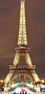 Illuminated Eiffel Tower at night in Paris wallpaper.