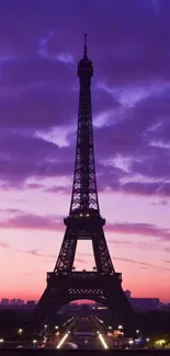 Eiffel Tower silhouette with a purple sunset sky in the background.