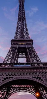 Eiffel Tower at sunset with a vibrant purple sky in the background.