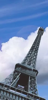 Eiffel Tower with cloudy blue sky.