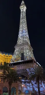 Illuminated Eiffel Tower shining against a dark night sky.