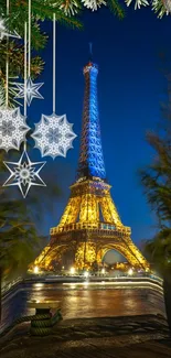 Eiffel Tower lit up at night with holiday decorations.