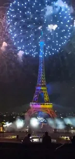 Eiffel Tower illuminated by fireworks at night.