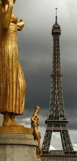 Eiffel Tower with golden statue under a cloudy sky.