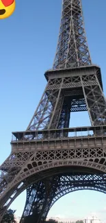 Eiffel Tower with heart emoji in sky blue background.