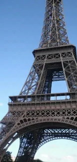 Eiffel Tower set against a clear blue sky with architectural detail.