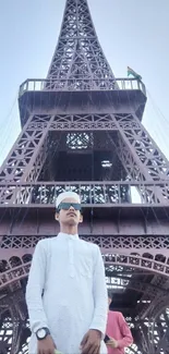 Individual in front of the Eiffel Tower, showcasing fashion and architecture.