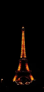 Eiffel Tower glowing at night over a dark sky, perfect mobile wallpaper.