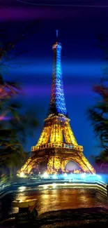 Eiffel Tower glowing at night with blue and gold hues.