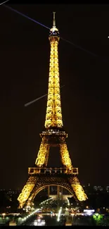 Eiffel Tower glowing at night in Paris.