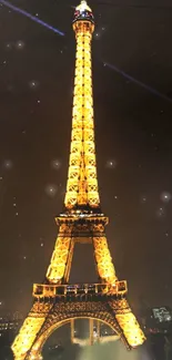 Eiffel Tower glowing at night with stars and city lights.