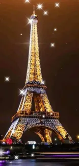 Eiffel Tower illuminated at night against dark sky.