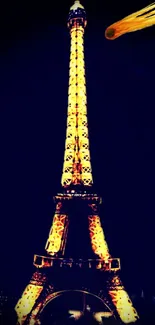 Eiffel Tower glowing at night with a dark sky backdrop.