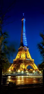 Illuminated Eiffel Tower against a blue night sky in Paris.