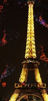 Night view of glowing Eiffel Tower with colorful heart lights.