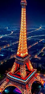 Eiffel Tower illuminated at night with city lights.
