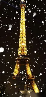 Eiffel Tower lit up at night with snow falling.