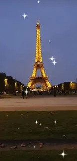 Eiffel Tower glowing at night with city lights.