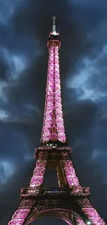 Eiffel Tower glowing in purple at night under a stormy sky.