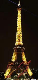 Eiffel Tower illuminated against the night sky, iconic Paris landmark.