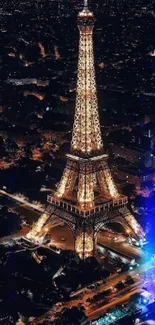 Night view of the illuminated Eiffel Tower with surrounding cityscape.