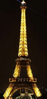 Eiffel Tower brilliantly illuminated at night in Paris.