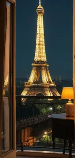 Night view of the Eiffel Tower glowing from a Parisian balcony.