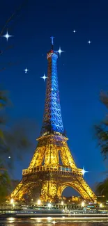 Eiffel Tower illuminated at night with scenic plants in foreground.