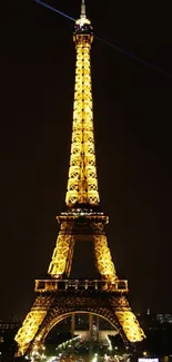 Eiffel Tower illuminated beautifully at night against a dark sky in Paris.