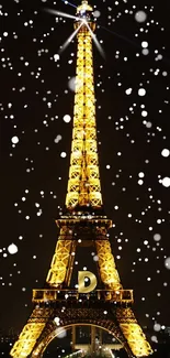 Eiffel Tower illuminated at night with falling snow.