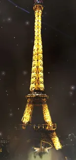 Eiffel Tower glowing at night in golden light under starry sky.