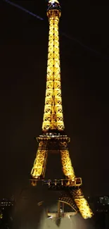 Eiffel Tower illuminated against a dark night sky, perfect for a mobile wallpaper.