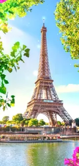 Vibrant Eiffel Tower wallpaper with greenery and flowers against a blue sky.