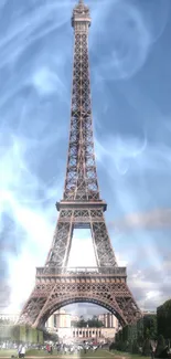 Beautiful view of the Eiffel Tower beneath a clear blue sky, surrounded by greenery.