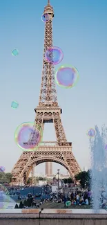 Eiffel Tower under a clear blue sky with fountains in the foreground.