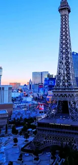 Elegant Eiffel Tower at sunset with blue sky and urban backdrop.