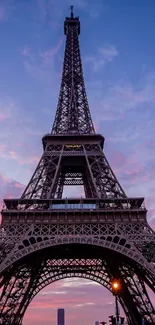 Eiffel Tower at sunset with vibrant pink skies in a stunning mobile wallpaper.