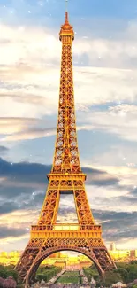 Eiffel Tower glowing at sunset with a dramatic sky in the background.