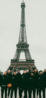 A group standing in front of the Eiffel Tower.