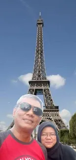 Tourists at the Eiffel Tower with a clear blue sky backdrop.