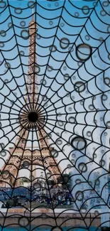 Eiffel Tower with spider web overlay on blue sky background.