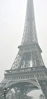 Eiffel Tower captured in a snowy winter scene for mobile wallpaper.