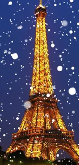 Eiffel Tower illuminated at night with snow falling in Paris.