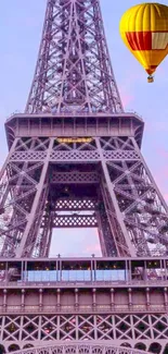 Eiffel Tower with a hot air balloon in pastel sky.